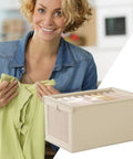 No Stress Foldable Storage Cubes With Heavy Duty Dual Handles For Thick Blankets Linens And Winter Jackets shown with a woman holding a shirt.