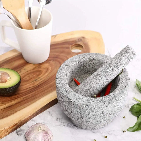 Unpolished Granite Mortar And Pestle Set With Silicone Lid 2 Cup Capacity on kitchen counter with avocado and garlic