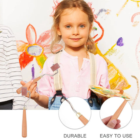 Professional Heavy Duty Rubber Ink Roller For Printmaking And Canvas Painting Smooth Glide Surface held by a child with a paint palette.