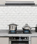 Kitchen with Peel And Stick Backsplash Tiles 12x12 White Marble Design, showcasing self adhesive subway tiles above a stove.