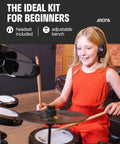Child playing Electronic Drum Set With 4 Quiet Mesh Pads And 2 Pedals Portable Solid Build Bluetooth Ready Includes Drum Module Throne Headphones.