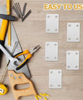 Set Of Twenty Heavy Duty Stainless Steel Flat Mending Plates To Brace Wobbly Wood Shelves And Patch Up Broken Furniture Projects With Rock Solid Strength That Handles Daily Grind Without Breaking A Sweat on a work table with tools.