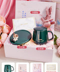 Smart Coffee Mug Warmer Set It And Forget It Design Automatic Gravity Detection Touch Controls Three Heat Levels Desk Beverage Heater gift set in an elegant box with floral decorations.