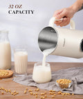 8 In One Nut Milk Maker And 32 Oz Self Cleaning Automatic Blender pouring almond milk into glass on wood table.