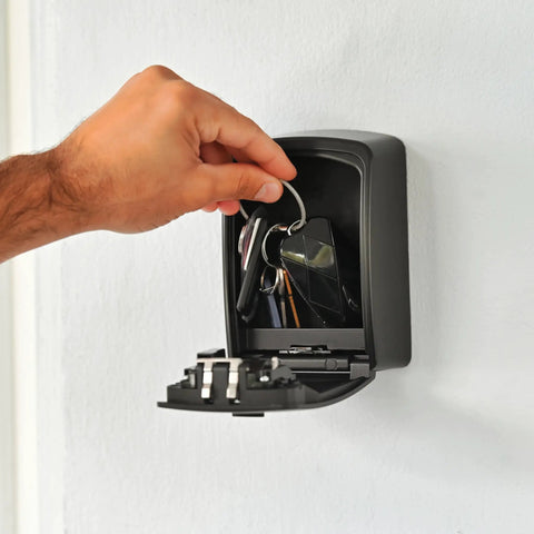 Hand accessing keys in XXL Wall Mount Key Lock Box Outdoor Key Safe Waterproof Heavy Duty Metal Body With 4 Digit Combination