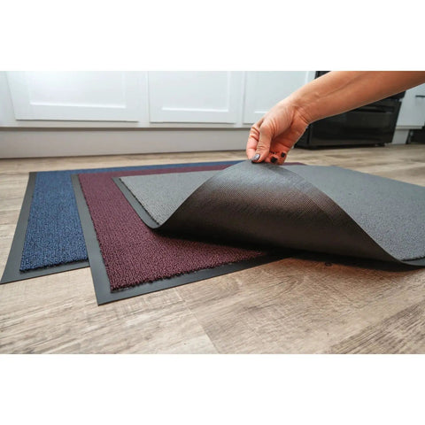 Person lifting corner of Ovation Entrance Mat 3 by 6 Blue for Home or Office Heavy Duty Tufted Decalon Pile on floor