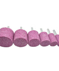 Set of six cylindrical pink stone grinding bits with 1/4 inch shanks, used for rotary tools; varying sizes, front view.