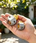 Upgrade Your Sprinkler Setup With This Solid Brass Garden Hose Repair Kit Featuring Two Sets Of Universal Connectors For 5/8 Inch And 3/4 Inch Tubes Plus Heavy Duty Male Female Mender Fittings To Fix Leaks Fast., close-up of brass hose repair connectors in hand