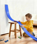 Child playing with 15 Ft Flexible Race Track Set With Two Lane Track And 6 Toy Cars For Kids, easy to set up and portable PVC track.