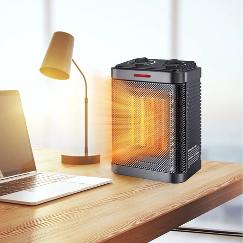 Tiny But Mighty 1500W PTC Ceramic Space Heater With Thermostat, 2S Rapid Heating on a desk near a lamp and laptop
