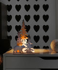 Woodsy Bear Silhouette Table Lamp For Cabin And Lodge Decor lit on nightstand showing metal silhouette of bear and trees