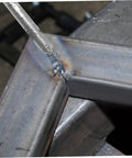 Close-up of 12 Pc Aluminum Filler Rods Welding Sticks for Reliable Low Temp Welds in use on metal surface corner