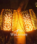 Close-up of lit Six Pack Solar Torch Lights with Realistic Flickering Flame, showcasing intricate design and bright glow at night.