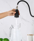 Top Shelf Slick Pull Down Kitchen Faucet Sprayer Head Replacement In Matte Black With Heavy Duty Connectors And Three Way Spray Patterns For No Fuss Quick Cleanups Around Your Home pouring water into a glass pitcher.