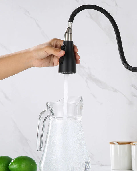 Top Shelf Slick Pull Down Kitchen Faucet Sprayer Head Replacement In Matte Black With Heavy Duty Connectors And Three Way Spray Patterns For No Fuss Quick Cleanups Around Your Home pouring water into a glass pitcher.