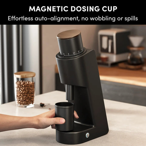Rock Solid Single Dose Coffee Grinder With Brawny 38 Mm Conical Burrs And Butter Smooth Stepless Dial For Bold Espresso Pour Over Pulls Low Retention Anti Static Frame In Matte Black with magnetic dosing cup in use.