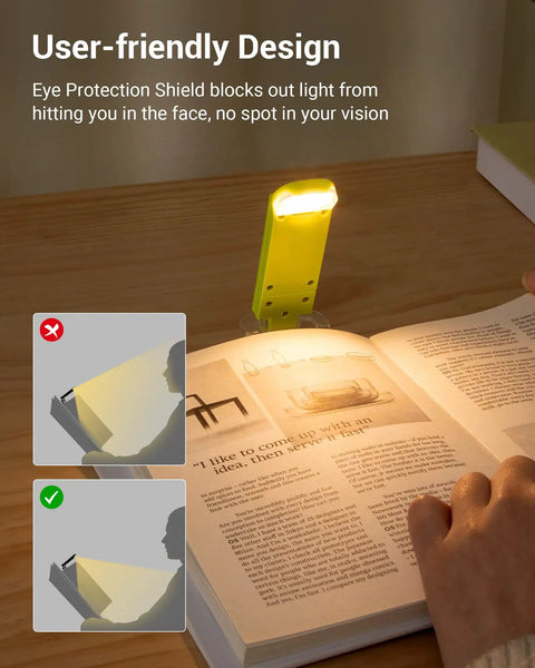 Go-To Clip On Book Light For Reading At Night With Amber And Warm White Glow Four Lighting Modes Eye Protection USB Powered Flexible Clip Lamp For Kids And Adults Adjustable Brightness Green on a book at night, illuminating pages with amber glow.