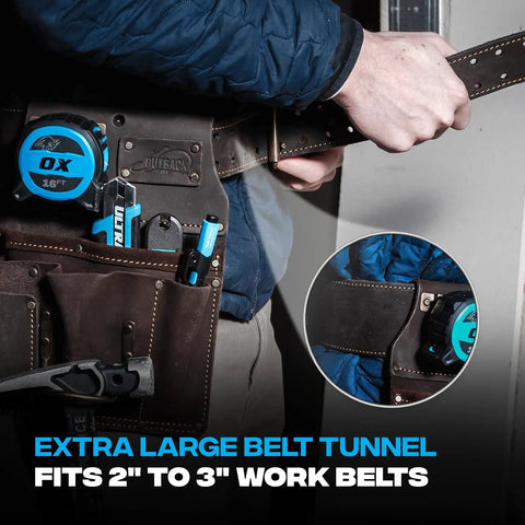 Person wearing oil tanned leather drywall tool pouch with hammer loop and 12 pockets, holding a tape measure, fits 2-3" belts.