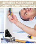 Man installing 12 Piece Black Triangle Corner Brackets For Furniture Reinforcement And Shelf Support on a cabinet