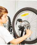 Heavy Duty Disc Brake Rotor Kit For Mountain Bike With Front Rear Pads Set 160mm Mechanical Caliper Forged Aluminum Build Killer Stopping Power Gnar Friendly Silver being installed on a bike wheel by a child.