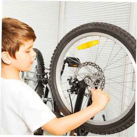 Heavy Duty Disc Brake Rotor Kit For Mountain Bike With Front Rear Pads Set 160mm Mechanical Caliper Forged Aluminum Build Killer Stopping Power Gnar Friendly Silver being installed on a bike wheel by a child.