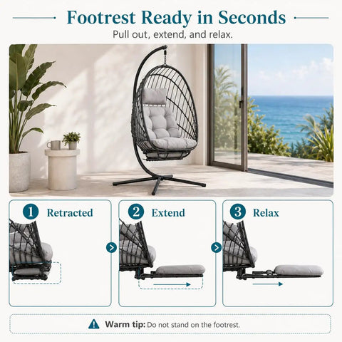 Comfy Hanging Egg Chair With Leg Rest And Stand In Gray, Rattan Wicker Swing Hammock by window showing footrest adjustment.