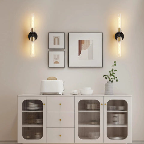 Mermiviok Matte Black Wall Sconces Set of 2, Clear Glass Vanity Lights mounted on a stylish wall above a modern sideboard.