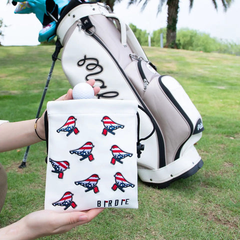 Premium Leather Golf Pouch With Drawstring Closure For Balls And Tees in front of golf bag on grass