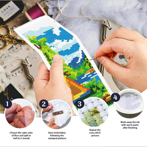 Person crafting with Camping Theme DIY Cross Stitch Bookmark Kit For Beginners, showing mountain view design in progress.