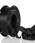 Glass Fiber Reinforced PETG Filament 1.75mm spool frosted black next to a 3D-printed skull for Bambu Lab printers
