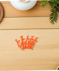 Orange clips on table from 5 Piece Glider Plane Bracket Kit With Rubber Band Power For Do It Yourself Aircraft Builds