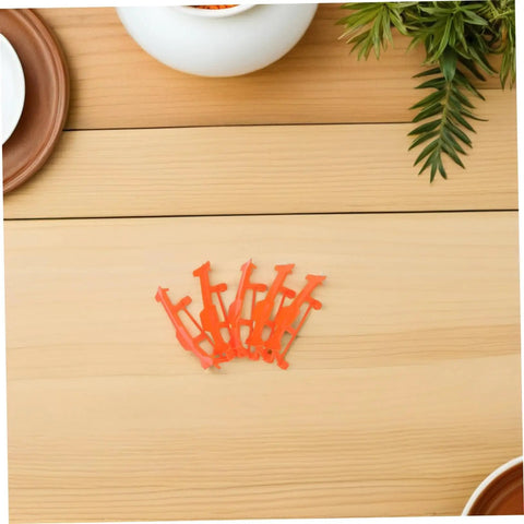 Orange clips on table from 5 Piece Glider Plane Bracket Kit With Rubber Band Power For Do It Yourself Aircraft Builds