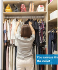Person in closet with clothes, showing 8 Pack Adjustable Window Security Bars For Sliding Doors 15.7 To 27.6 Inches Half Inch Diameter White With Rubber Tips Easy Install Window Lock Bars For Home Bathroom Cupboard Extra Protection And Peace Of Mind.