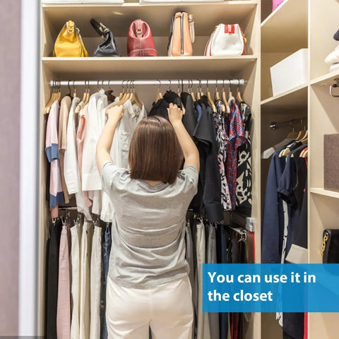Person in closet with clothes, showing 8 Pack Adjustable Window Security Bars For Sliding Doors 15.7 To 27.6 Inches Half Inch Diameter White With Rubber Tips Easy Install Window Lock Bars For Home Bathroom Cupboard Extra Protection And Peace Of Mind.