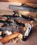 Professional Grade Bailey Four Plane Cutting Hardwood Butter Smooth With Precision Cast Iron Body And Simple Rapid Adjustment Levers For Weekend Warriors Wanting Killer Surface Finish with shavings and logo.