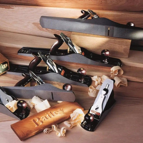 Professional Grade Bailey Four Plane Cutting Hardwood Butter Smooth With Precision Cast Iron Body And Simple Rapid Adjustment Levers For Weekend Warriors Wanting Killer Surface Finish with shavings and logo.