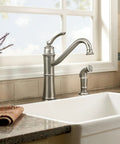 Wetherly Mediterranean Bronze High Arc Kitchen Faucet With Side Spray installed in a modern kitchen setting.