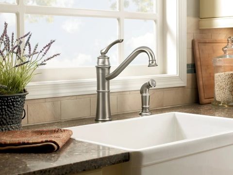 Wetherly Mediterranean Bronze High Arc Kitchen Faucet With Side Spray installed in a modern kitchen setting.