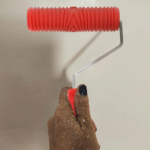 Top Tier Premium Grain Pattern Paint Roller With Slick Plastic Handle For Smoothing Over Bare Drywall and crafting embossed textures held in hand.