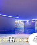 25 Pack Solderless LED Tape Light Connectors Tape To Tape Quick Screw Down Terminal Block 2 Pin For Strip Lights 0.3 Inch 8mm 5V 12V 24V Single Color White DIY Friendly, shown in a swimming pool setting with blue LED accent lighting, close-up view of terminal block.