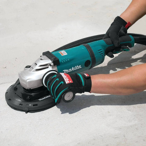 Person using Makita grinder with 7 Inch Dust Extraction Surface Grinding Shroud With Soft Brushes And Four Spring Suspension Keeps It Flush During Use Removable Edge Piece For Flush Surfaces Standard Hose Fitting Fits Most Vacs on concrete