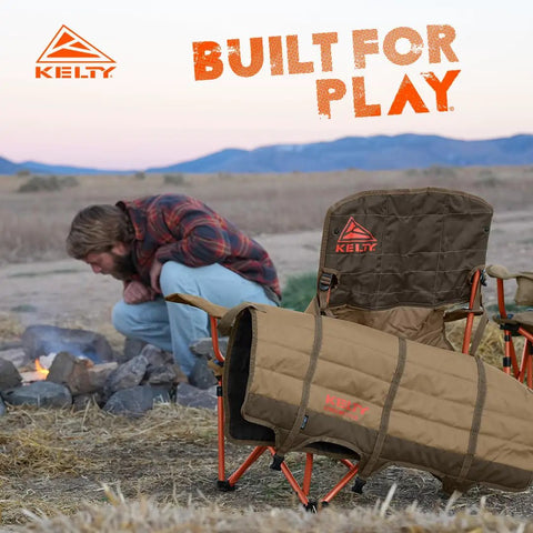 Lowdown Chair With Durable Bungee Cord Build In Beluga Color For Outdoor Concerts Sidelines And Lounging At Home One Foot Off The Ground Slight Recline Pet And Kid Friendly Built To Last next to a campfire with mountain backdrop