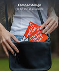 Person placing 3 In 1 Rapid Antigen Test For Covid And Flu A And B At Home OTC Kit in handbag, emphasizing portability.