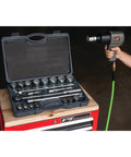 Person using M627 3 Quarter Inch Drive Heavy Duty Impact Wrench With Aluminum Housing, tool set on workbench