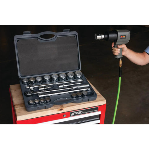 Person using M627 3 Quarter Inch Drive Heavy Duty Impact Wrench With Aluminum Housing, tool set on workbench