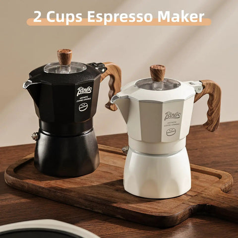 Stovetop Espresso Maker With Double Valve Tech Italian Moka Pot Brewed Fresh On Gas Or Electric Stove Top Shelf Coffee Brewer Set Includes Two Heavy Duty Mugs, featuring black and white designs on wooden tray.