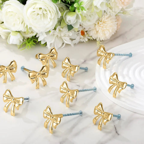 Dang Stylish Gold Bow Cabinet Handles Eight Pack Plus Heavy Duty Screws Easy Install Drawer Knobs on marble surface.