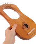 7 String Lyre Harp Starter Kit With Tuning Wrench Extra Strings And Music Sheet Book wooden mini harp in hand