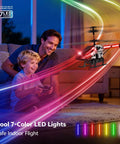 Man and boy playing with Kids RC Helicopter With Altitude Hold And One Button Takeoff Landing featuring LED lights indoors.