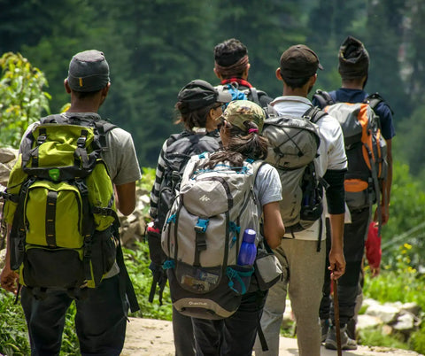 Group of hikers with backpacks on a forest trail, ideal for testing Emergency Fire Starter Pouches For Camping And Outdoor Adventures.